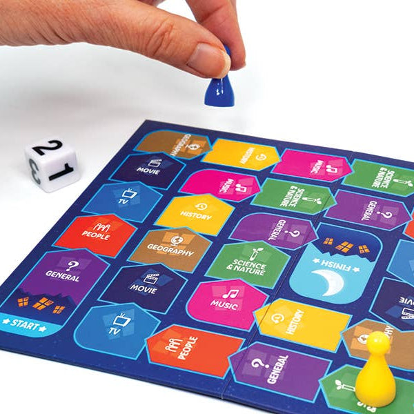 Colorful board game with game pieces and a die on a white background