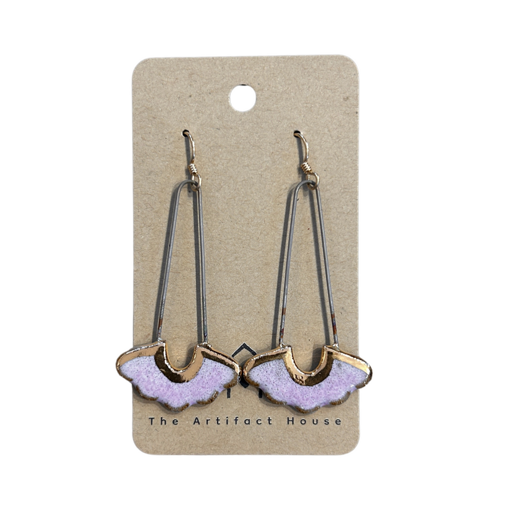 Pair of earrings on a 'The Artifact House' branded card against a white background