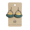 Pair of patina and gold earrings on a 'The Artifact House' branded card against a white background