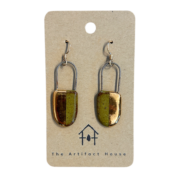 Pair of gold and green earrings on a card with 'The Artifact House' branding.