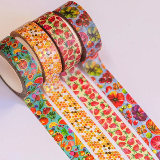 Three rolls of colorful washi tape with fruit and honeycomb patterns on a white background.