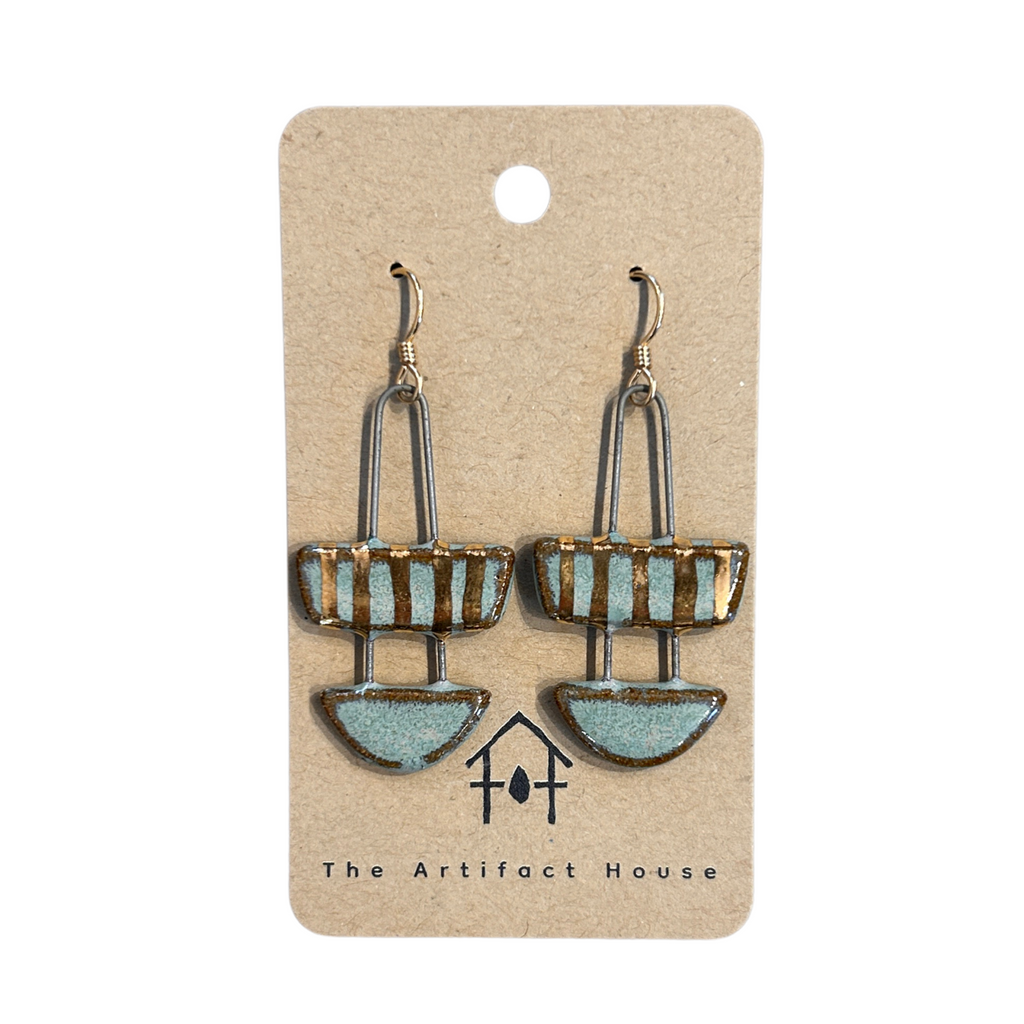 Pair of earrings on a card with 'The Artifact House' branding