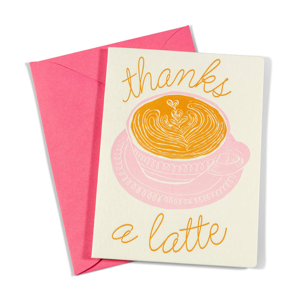 Greeting card with 'thanks a latte' text and a cup illustration, accompanied by a pink envelope.